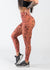 Chest Down Side View One Leg Up Wearing Empowered Leggings With Pockets | Orange Leopard