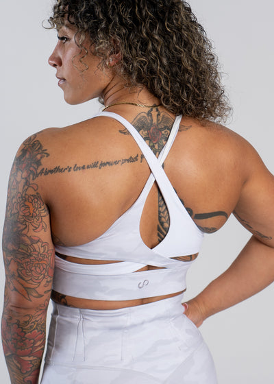 Waist Up Back View with One Hand on Hip Wearing Empowered Double Brushed Bra | Snow Camo
