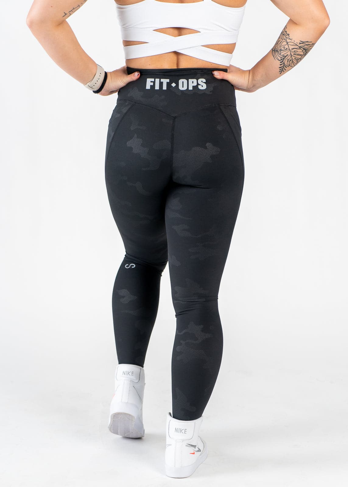 Chest Down Back View Hands on Hips Wearing Empowered Leggings x FIT OPS | Black Camo