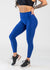 Chest Down 3/4 Front View With One Hand on Lower Back Wearing Dream Leggings With Pockets | Blue Razz