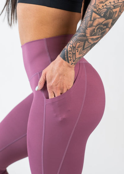 Chest to Thigh Side View with Hand in Pocket Wearing Empowered Leggings With Pockets | Berry