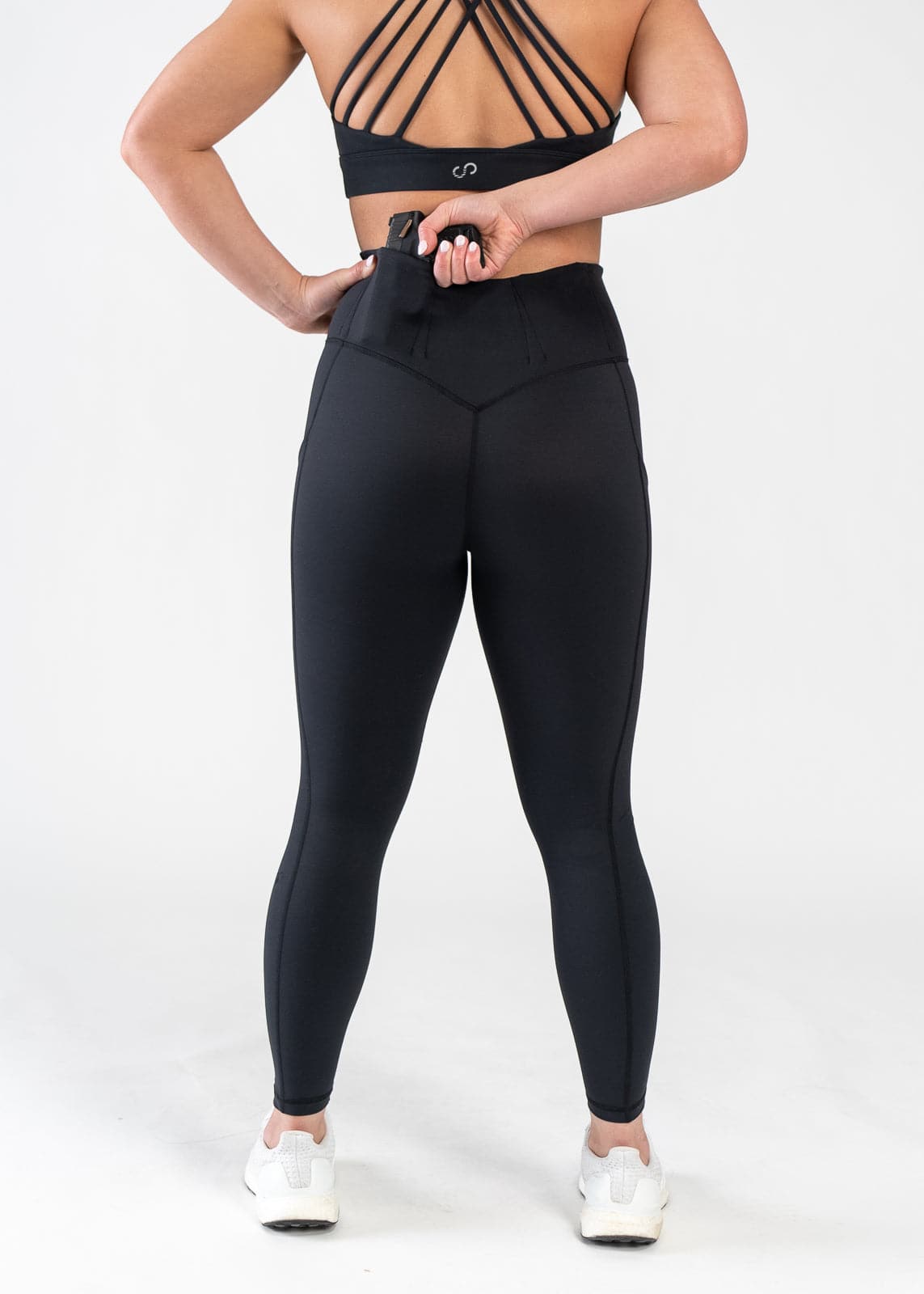 Concealed Carry Leggings With Pockets Shoulders Down Back View Reaching for Concealed Carry | Black