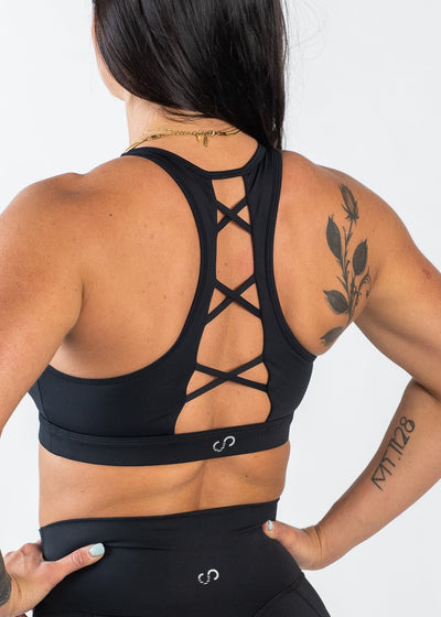 Chin to Waist with Hands on Hips Wearing Empowered Laced Back Sports Bra | Black