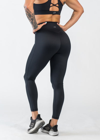 Chest Down 3/4 Back View with Hands on Hips Wearing Empowered Leggings | Black