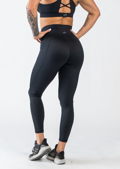 Chest Down 3/4 Back View with Hands on Hips Wearing Empowered Leggings With Pockets | Black