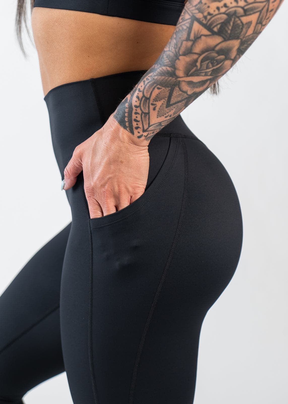 Chest to Thigh Side View with Hand in Pocket Wearing Empowered Leggings With Pockets | Black