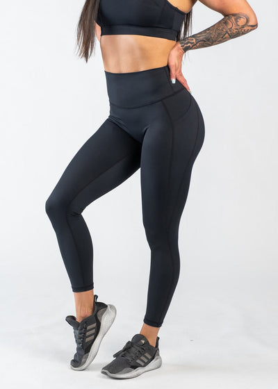 Chest Down 3/4 Front View One Leg Up Wearing Empowered Leggings With Pockets | Black