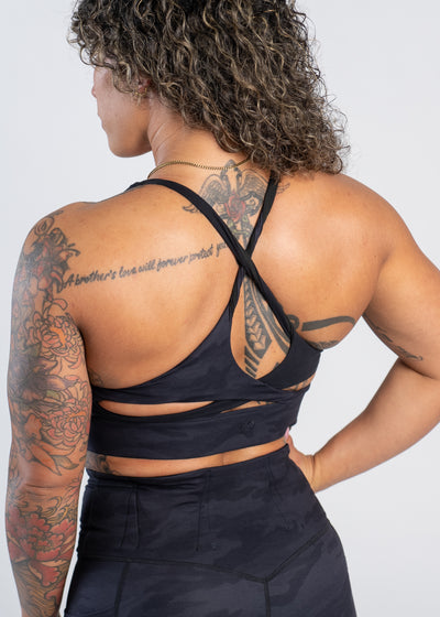 3/4 Back View With One Hand On Hip Hip Wearing Empowered Double Brushed Bra | Black Camo