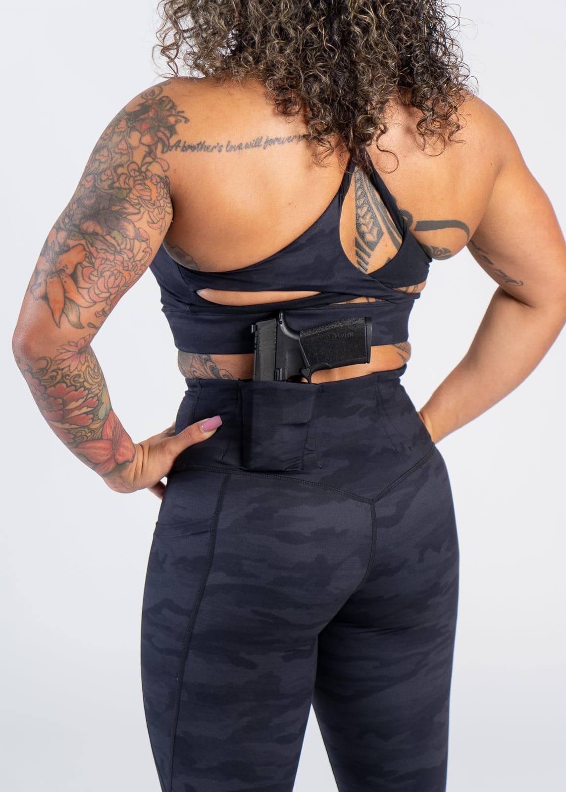 Concealed Carry Leggings With Pockets - Shoulders Down Back View with Hands on Hips | Black Camo