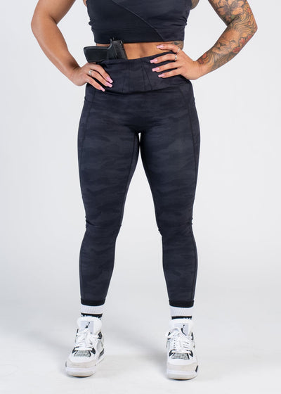 Concealed Carry Leggings With Pockets - Shoulders Front Back View Reaching for Concealed Carry | Black Camo