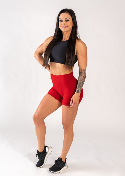 Full Body 3/4 Front View One Leg Up and One Hand on Hip Wearing Dream 4" Shorts | Cherry