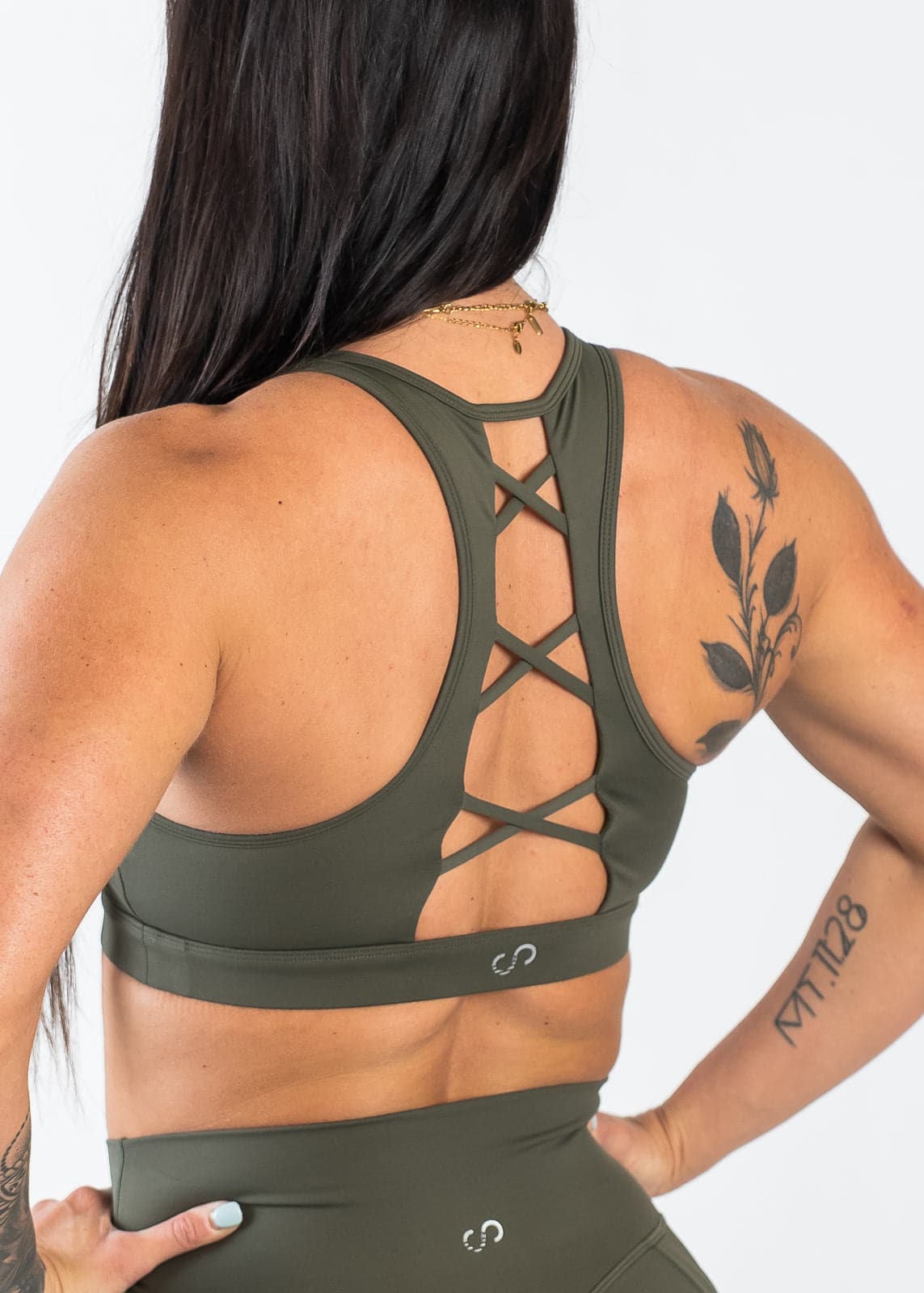 Chin to Waist with Hands on Hips Wearing Empowered Laced Back Sports Bra | OD Green