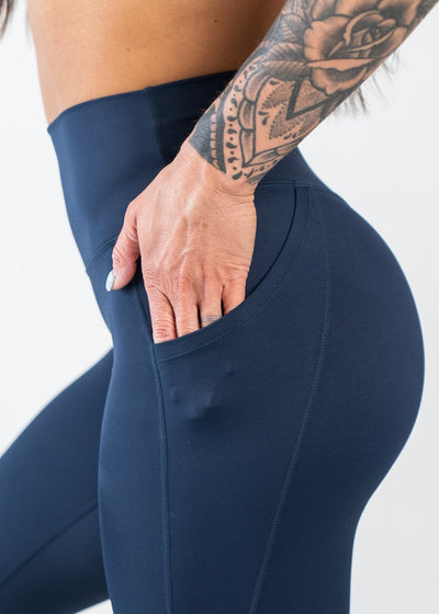 Chest to Thigh Side View with Hand in Pocket Wearing Empowered Leggings With Pockets | Blue