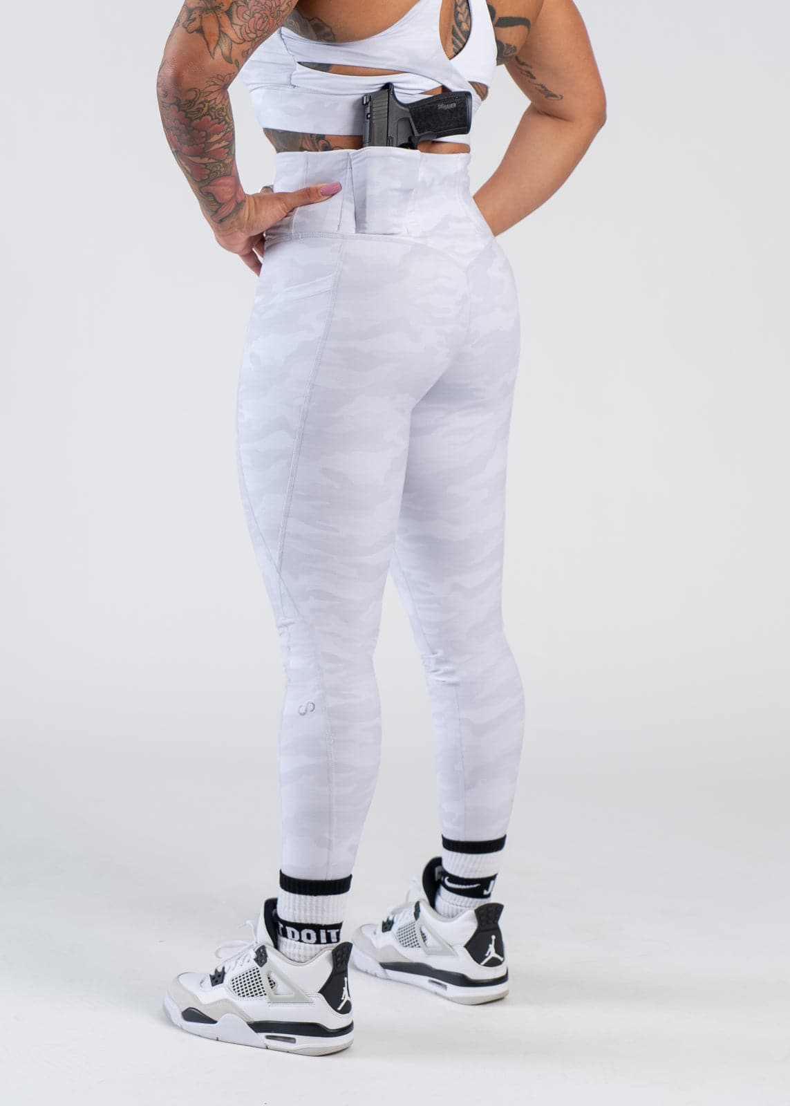 Concealed Carry Leggings With Pockets Shoulders Down 3/4 Back View with Hands on Sides | Snow Camo
