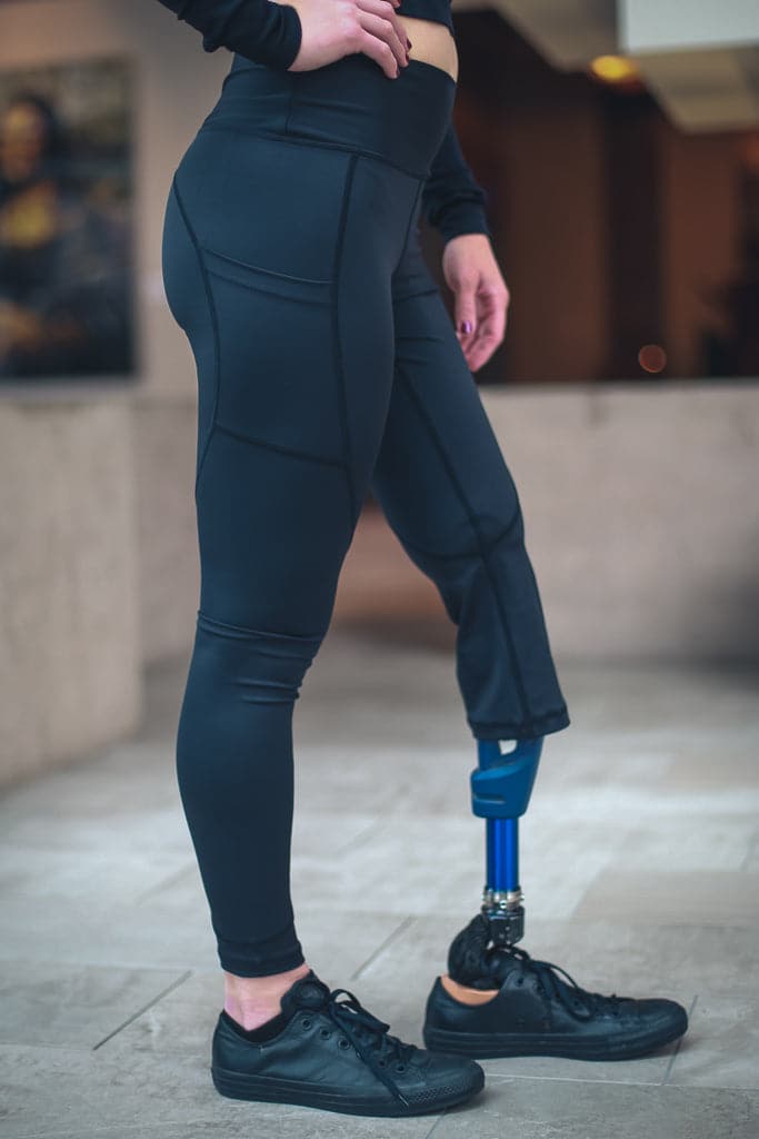 Left side view of right leg below the knee amputee leggings with pockets-Black.