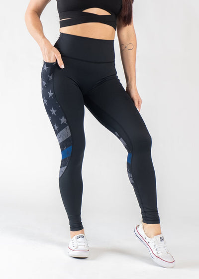 Chest Down Front View One Hand in Pocket Wearing Empowered Leggings | Blue Line