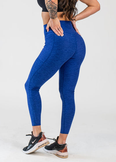 Chest Down 3/4 Back View With Hands on Hips Wearing Dream Leggings With Pockets | Blue Razz
