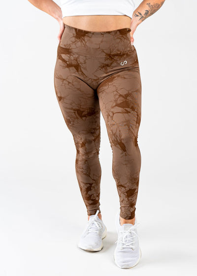 Shoulders Down Front View in Contour Seamless Leggings with Hands on Lower Back - Brown Marble