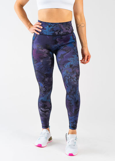 Waist Down Front View with One Hand on Side Wearing Empowered Leggings | Galaxy