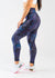 Waist Down Side View Facing Left with One Leg Bent Wearing Empowered Leggings | Galaxy