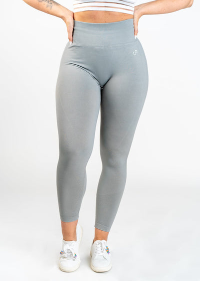 Shoulders Down Front View in Contour Seamless Leggings with Hands on Lower Back - Ash
