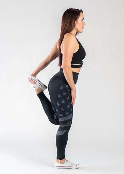 Full Body Side View Performing a Quad Stretch Wearing Empowered Leggings | Camo Line