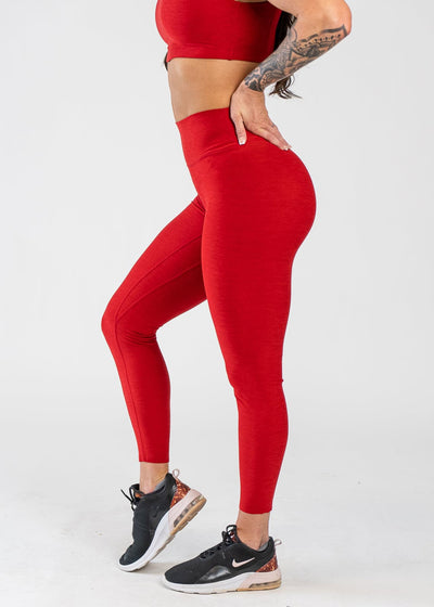 Chest Down Side View With One Hand on Lower Back Wearing Dream Leggings | Cherry