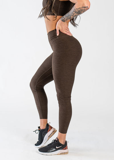 Chest Down Side View With One Hand on Lower Back Wearing Dream Leggings | Cocoa