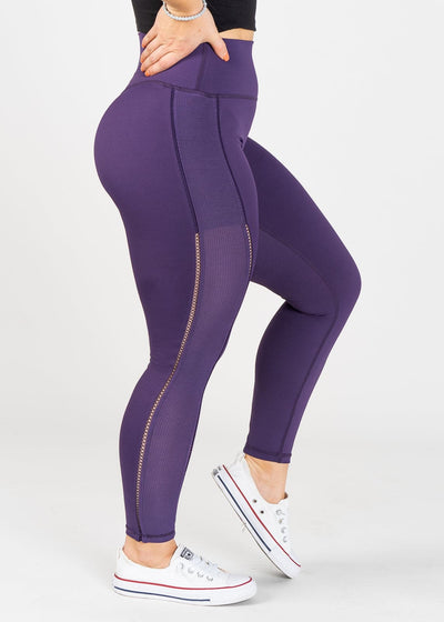 Chest Down Side View One Leg Up Wearing Empowered Leggings With Cut Outs | Purple