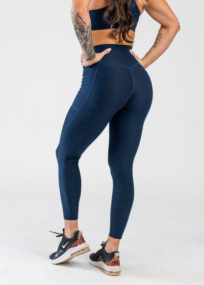 Chest Down 3/4 Back View With Hands on Hips Wearing Dream Leggings With Pockets | Deep Blue
