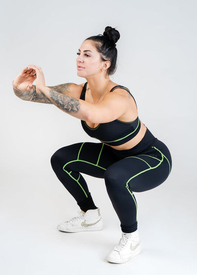 Full Body 3/4 Side View Performing a Squat in Neon Green Contour Bra