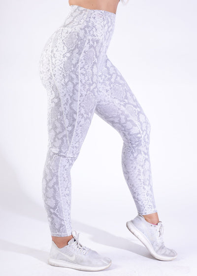 Waist Down Side View with One Leg Bent Wearing Empowered Leggings | Cobra