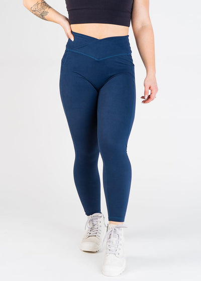 Chest Down Front View With One Hand On Hip Wearing Empowered Double Brushed Leggings - Navy Blue