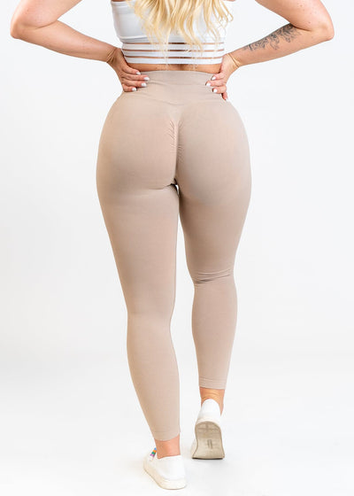 Shoulders Down Back View in Contour Seamless Leggings with Hands on Lower Back - Shell