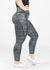 Chest Down Side View One Leg Up Wearing Empowered Leggings With Pockets | Black/Silver