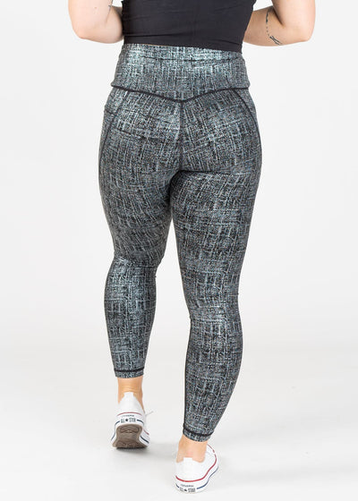 Chest Down Back View Wearing Empowered Leggings With Pockets | Black/Silver