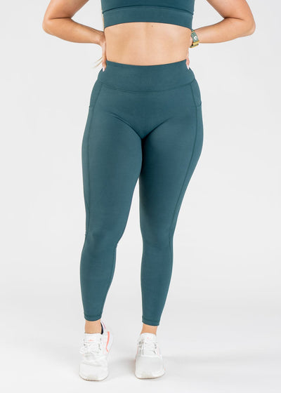 Chest Down Front View With Hands On Hips Wearing Empowered Double Brushed Leggings - Pine
