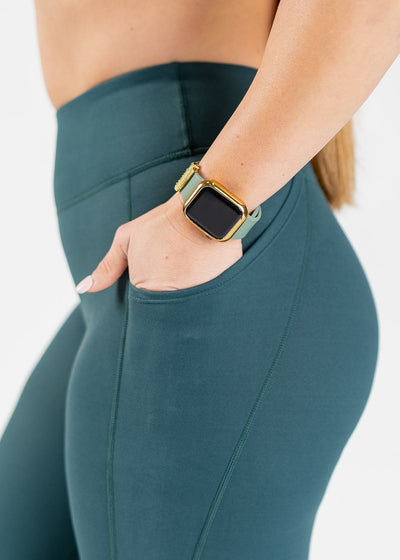 Chest to Thighs Side View Close Up with One Hand in Pocket Wearing Empowered Double Brushed Leggings - Pine