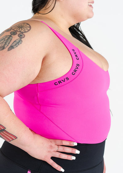 Waist Up Side View Hands on Hips Plus Sized Model Wearing CRVS Crop Bra | Hot Pink