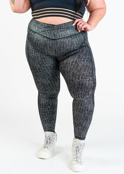 Chest Down Front View with One Hand on Hip Plus Sized Model Wearing Empowered Leggings With Pockets | Black/Silver