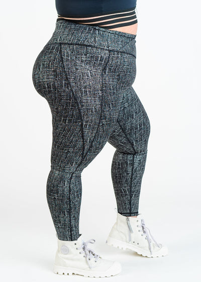 Chest Down Side View One Leg Up Plus Sized Model Wearing Empowered Leggings With Pockets | Black/Silver