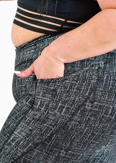 Chest to Thigh Side View with Hand in Pocket Plus Sized Model Wearing Empowered Leggings With Pockets | Black/Silver