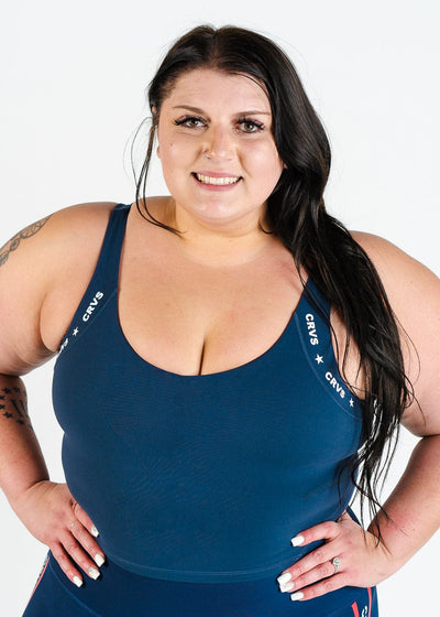 Waist Up Front View Hands on Hips Plus Sized Model Wearing CRVS Crop Bra | Navy Blue