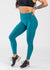 Chest Down 3/4 Front View With One Hand on Lower Back Wearing Dream Leggings | Teal